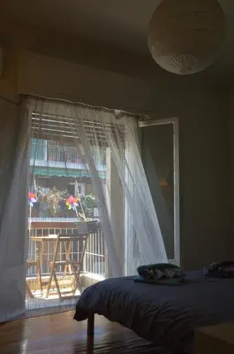 a bedroom with a bed and a window with a balcony at Home Sweet Home in Athens