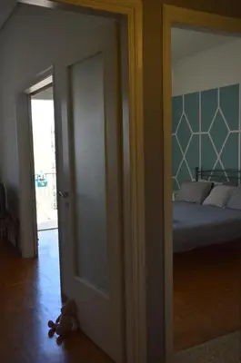 an open door to a bedroom with a bed at Home Sweet Home in Athens