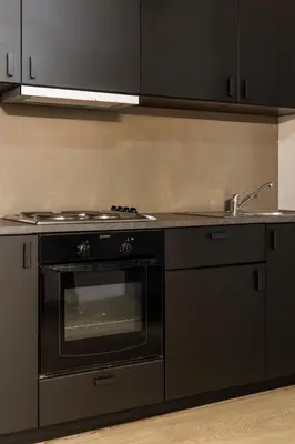 a kitchen with a stove and a sink at Art Suites Athens in Athens