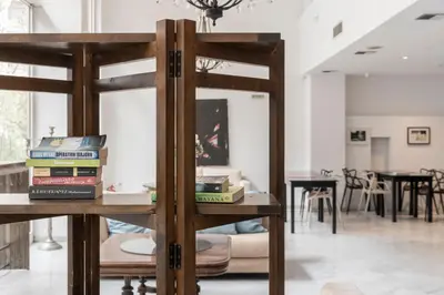 a pile of books sitting on a table in a room at Art Suites Athens in Athens