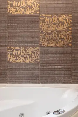 a close up of a tile wall with a bath tub at Art Suites Athens in Athens