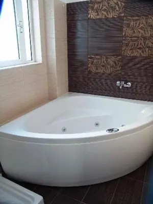 a white bath tub in a bathroom with a window at Art Suites Athens in Athens