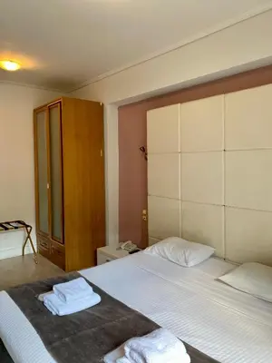 a bedroom with a bed with two towels on it at Art Suites Athens in Athens