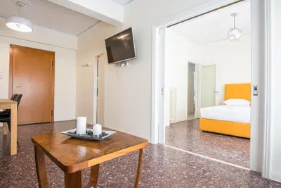 a living room with a table and a bed at Acropolis View Paradise Apartments in Athens