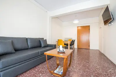 a living room with a couch and a table at Acropolis View Paradise Apartments in Athens