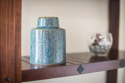 a blue glass bottle sitting on a wooden shelf at Acropolis View Paradise Apartments in Athens