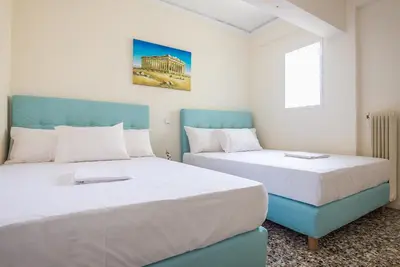 two beds sitting next to each other in a room at Acropolis View Paradise Apartments in Athens