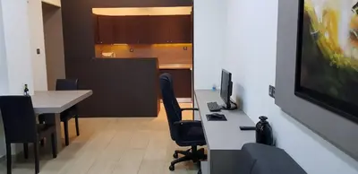 an office with a desk with a computer and chairs at Minimal Studio in Paleo Faliro in Athens