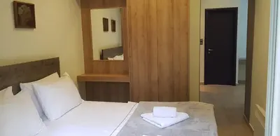 a bedroom with a bed with two towels on it at Minimal Studio in Paleo Faliro in Athens