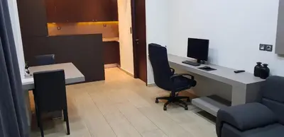an office with a desk with a computer and two chairs at Minimal Studio in Paleo Faliro in Athens