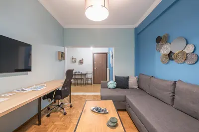 a living room with a couch and a table at Boutique Acropolis Apartment by Cloudkeys - Just 5 minutes walk to Acropolis Museum in Athens