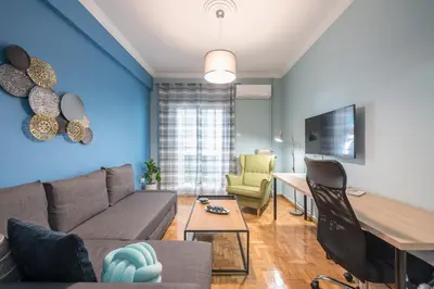a living room with a couch and a table at Boutique Acropolis Apartment by Cloudkeys - Just 5 minutes walk to Acropolis Museum in Athens
