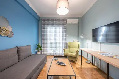 a living room with a couch and a table at Boutique Acropolis Apartment by Cloudkeys - Just 5 minutes walk to Acropolis Museum in Athens