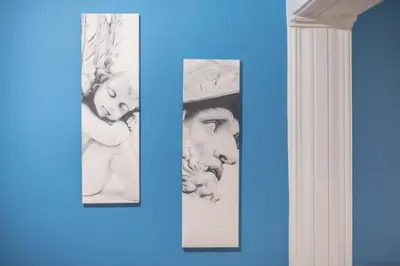 two framed photographs on a wall next to a doorway at Boutique Acropolis Apartment by Cloudkeys - Just 5 minutes walk to Acropolis Museum in Athens