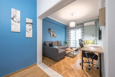 a living room with a couch and a table at Boutique Acropolis Apartment by Cloudkeys - Just 5 minutes walk to Acropolis Museum in Athens