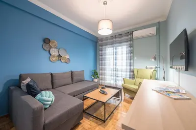 a living room with a couch and a table at Boutique Acropolis Apartment by Cloudkeys - Just 5 minutes walk to Acropolis Museum in Athens
