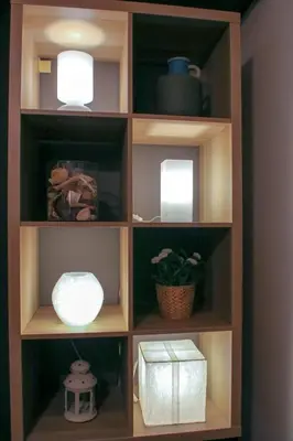 a book shelf with two lights and a plant at Angels in Athens