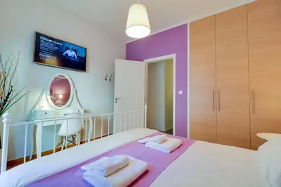 a bedroom with a bed with two towels on it at Angels in Athens
