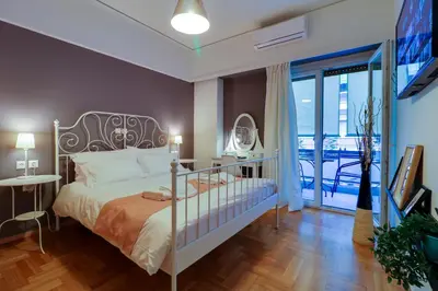 a bedroom with a bed and a balcony at Angels in Athens