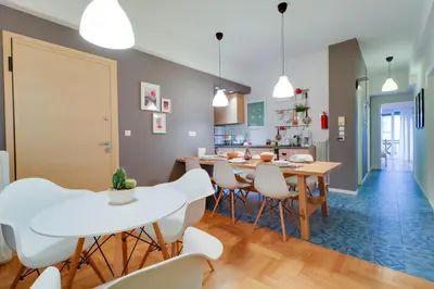 a kitchen and dining room with a table and chairs at Angels in Athens