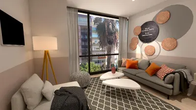 a living room with a couch and a large window at Great Living Apartments in Athens