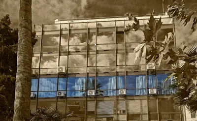 a building with a reflection of the sky in the windows at Great Living Apartments in Athens