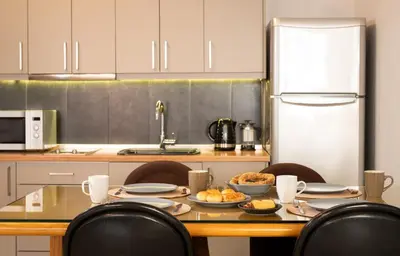 a kitchen with a table with food on it at Studio Pittaki - Large Studio in Athens Historic Center, Near Acropolis in Athens