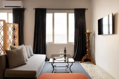 a living room with a couch and a table at Studio Pittaki - Large Studio in Athens Historic Center, Near Acropolis in Athens