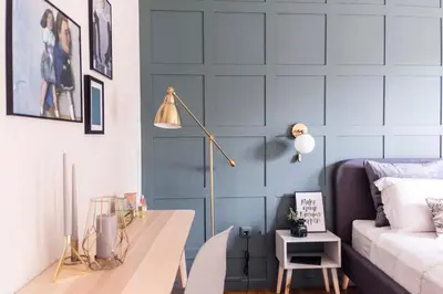 a living room with a blue accent wall at Agora Vista Acropolis in Athens
