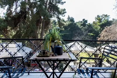 a table with a plant on top of a balcony at Agora Vista Acropolis in Athens