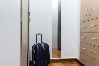 a suitcase is standing in a room with a doorway at Agora Vista Acropolis in Athens