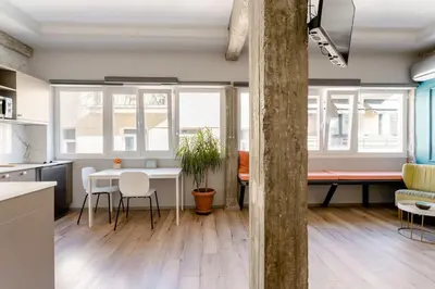 a kitchen and living room with a table and chairs at Na'maste Apartments in Athens