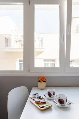 a table with two cups and a tray of food at Na'maste Apartments in Athens