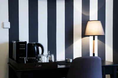 a room with a desk with a lamp and a chair at Athens Edition Guesthouse in Athens