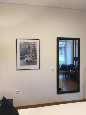 a mirror on a wall in a living room at Athens Edition Guesthouse in Athens