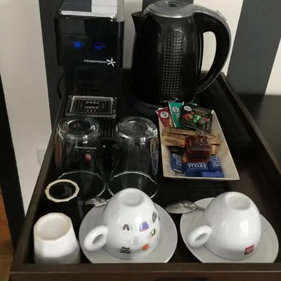 a tray with a tea set and a coffee maker at Athens Edition Guesthouse in Athens