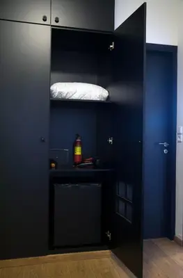 a black closet with a bed on top of it at Athens Edition Guesthouse in Athens