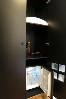 a refrigerator with its door open in a kitchen at Athens Edition Guesthouse in Athens