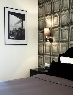 a bedroom with a wall covered in wooden panels at Athens Edition 2.0 in Athens