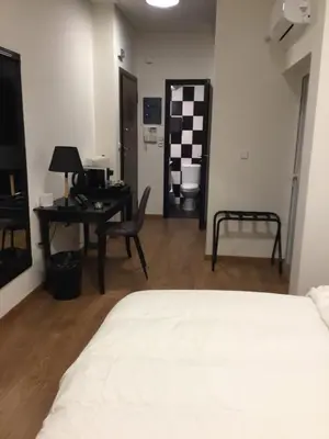 a bedroom with a bed and a desk and a table at Athens Edition 2.0 in Athens