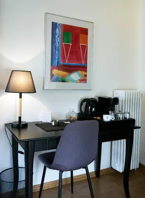 a desk with a chair and a lamp and a painting at Athens Edition 2.0 in Athens