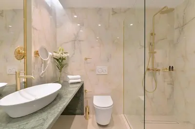 a bathroom with a toilet and a sink and a shower at Acropolian Spirit Boutique Hotel in Athens
