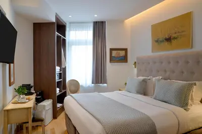 a hotel room with a large bed and a desk at Acropolian Spirit Boutique Hotel in Athens