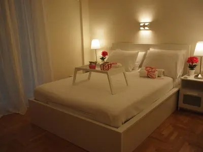 a bedroom with a bed with a table on it at Charming Studio Posh Quartier (Kolonaki Athens) in Athens