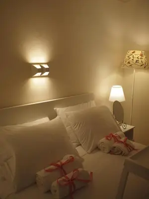a bedroom with a bed with two wrapped presents on it at Charming Studio Posh Quartier (Kolonaki Athens) in Athens