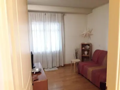a living room with a red couch and a window at Best Point To Stay in Athens