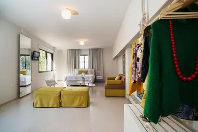a hotel room with a bed and a living room at Plaka Heart in Athens