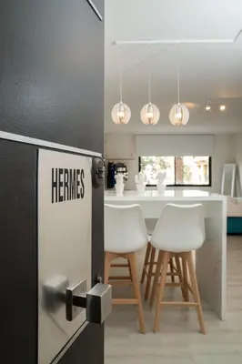 a kitchen with a refrigerator and two white chairs at Plaka Heart in Athens