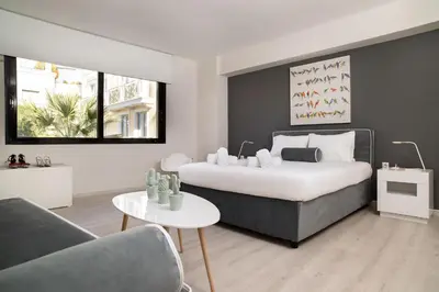 a bedroom with a bed and a couch and a table at Plaka Heart in Athens