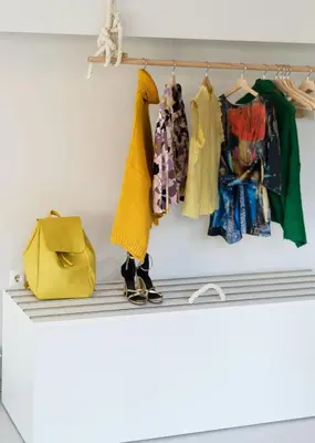 a shelf with clothes and a yellow purse at Plaka Heart in Athens